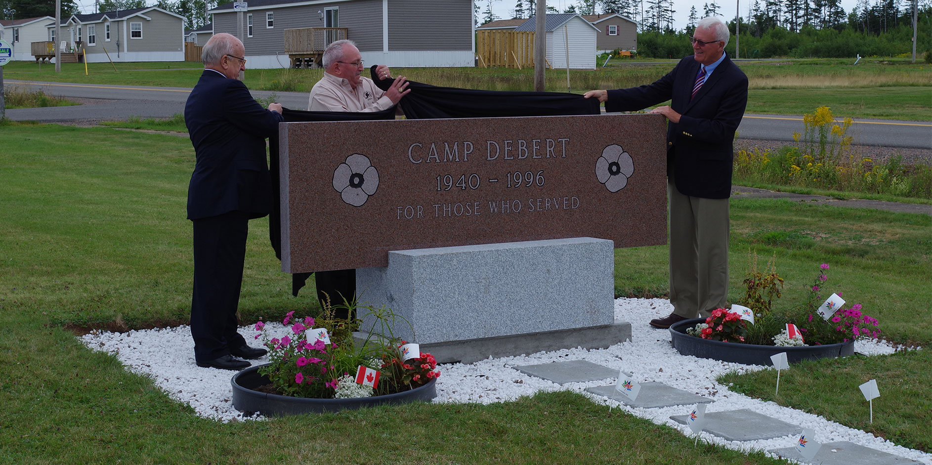 Picture of veterans unveiling a Camp Debert memorial